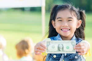 Child holding Money 